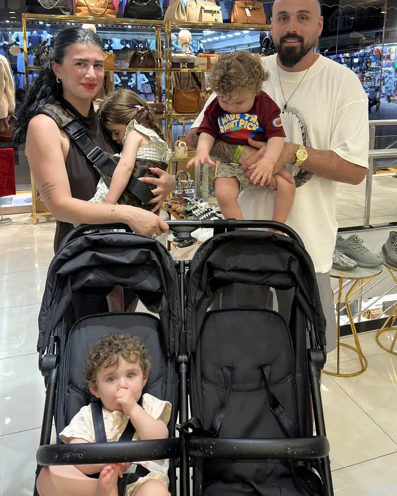 A family with a double stroller browsing in the store