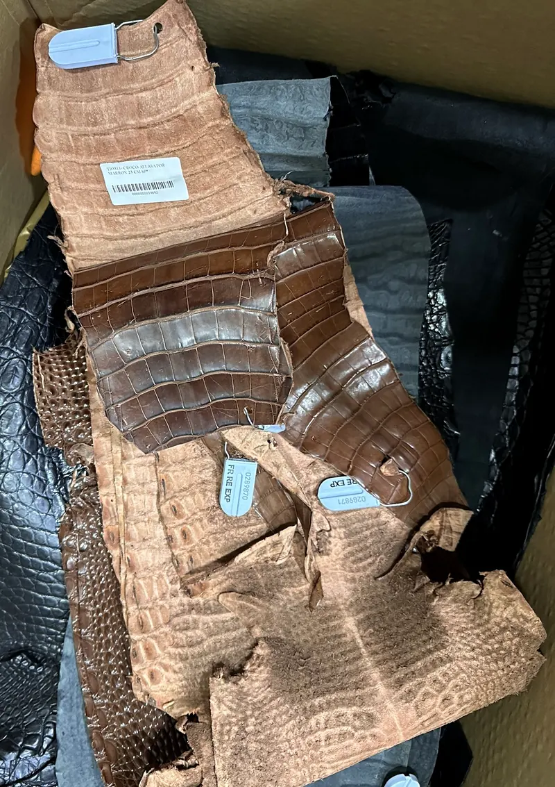 Leather hides with tags, waiting to be cut in the workshop